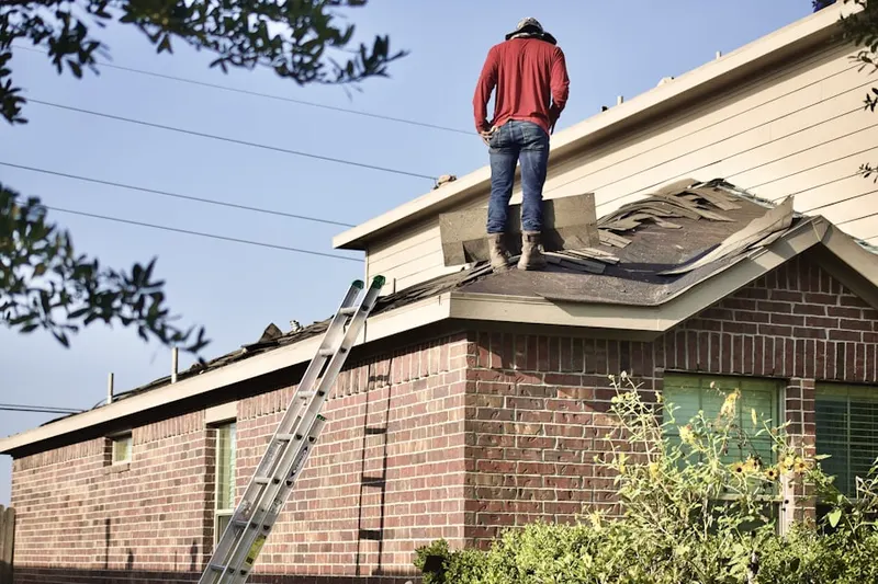 Professional roofer working on a residential roof in North Bay Shore